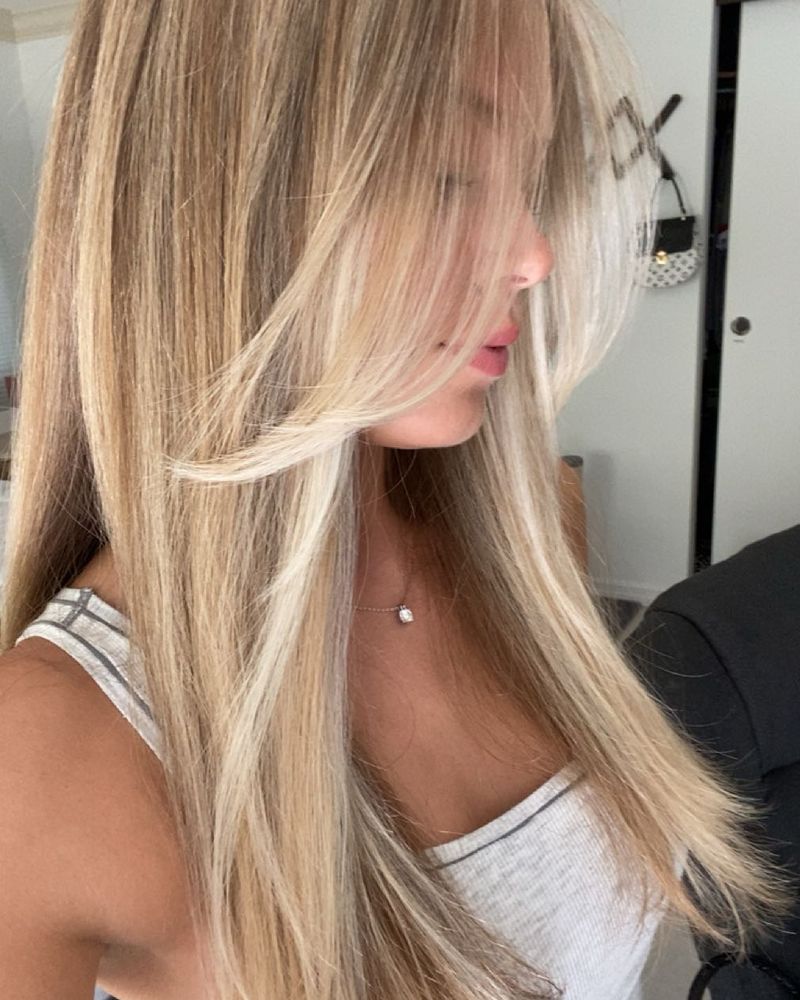 Long straight blonde hair finished by Dina